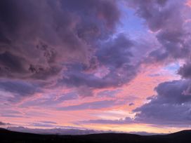 A sunset with clouds in the sky at The Faithfuls Cabin in Dingle, County Kerry