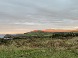 A landscape view of hills and fields by the ocean at The Faithfuls Cabin in Dingle, County Kerry