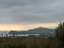 A coastal landscape with hills and ocean at The Faithfuls Cabin Dingle, County Kerry