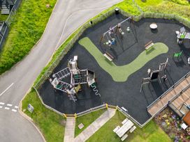 An outdoor playground with swings and various play equipment at Kruger (Pet) Penrith