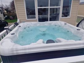 A hot tub on an outdoor patio at Barney's Retreat in Newquay