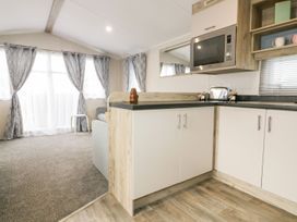 A kitchen with a microwave and a toaster at Barney's Retreat in Newquay