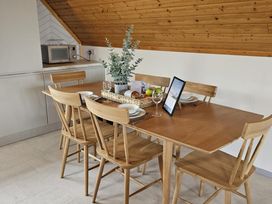 A dining room with a table set for meals at Kinder Lodge 3 Portreath