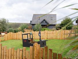 An outdoor space with a pirate ship and fence at Kinder Lodge 3 Spa (Pet) Redruth