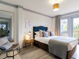 A bedroom with a bed and mirror at Kinder Lodge 3 Spa (Pet) Redruth