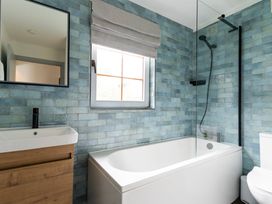 A bathroom featuring a bathtub, sink, toilet, and shower at Kinder Lodge 3 Spa (Pet) Redruth