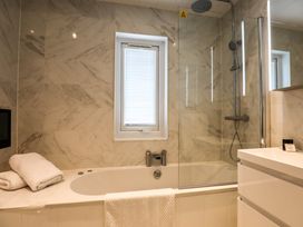 A bathroom with a bathtub and shower at Signature Lodge 4 in Redruth