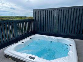 A hot tub on a deck at Signature Lodge 4 in Redruth