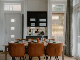 A dining room with a table and chairs at Wilde Spa in Carmarthen