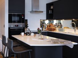 A kitchen with a modern countertop and appliances at Wilde Spa in Carmarthen