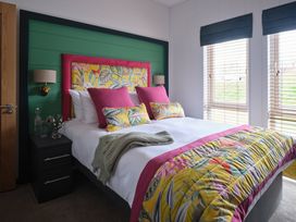 A bedroom with a bed and bedside table at Wilde Spa in Carmarthen