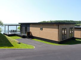 A building with a deck and seating area at Wilde Spa (Pet) Carmarthen