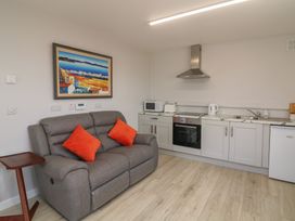 A kitchen area with appliances and seating at Radharc an Hook @ Estuary Bliss