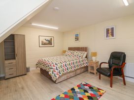 A bedroom with a bed and wardrobe at Radharc an Hook @ Estuary Bliss