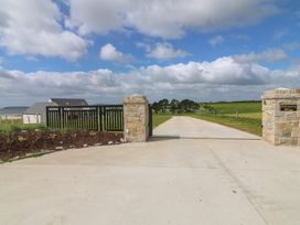 A gate at Estuary Bliss with farmland in the background