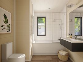 A bathroom with a bathtub and sink at Lonscale (Pet) Penrith