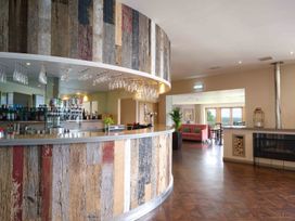 A bar area with seating and a fireplace at Lonscale (Pet) Penrith