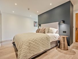 A bedroom with a bed and bedside table at Arvor Studio 1.0 in Bude