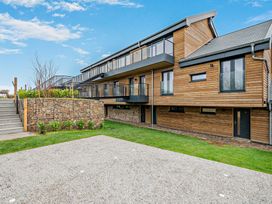 An outdoor view of a wooden building with a balcony at Arvor Wetroom Studio 1.0
