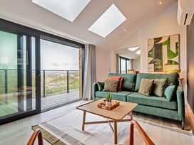 A living room with a sofa and a coffee table at Walesborough Penthouse 2.0 in Marhamchurch