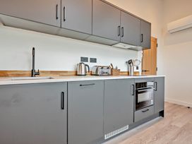 A kitchen with a sink, kettle, and toaster at Walesborough Penthouse 2.0 in Marhamchurch