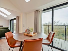 A dining room with a table and chairs at Walesborough Penthouse 2.0 in Marhamchurch
