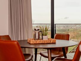 A dining room with a table and chairs at Walesborough Penthouse 2.0 in Marhamchurch