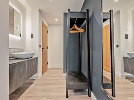 A bathroom with a sink and coat rack at Walesborough Penthouse 2.0 in Marhamchurch