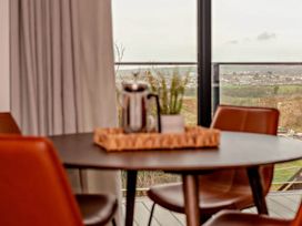 A dining room with a table and chairs at Whalesborough Penthouse 2.0 Marhamchurch