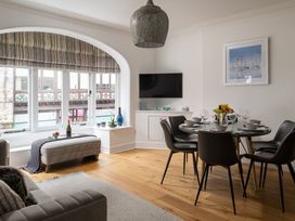 A dining room with a table set for meal at Tides Door in Dartmouth