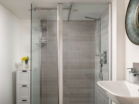 A bathroom with a shower and sink at Tides Door in Dartmouth