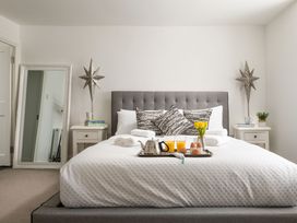 A bedroom with a bed and breakfast tray at Tides Door in Dartmouth