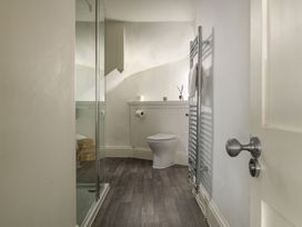 A bathroom with a shower and toilet at Tides Door in Dartmouth