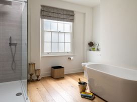 A bathroom with a bathtub and shower at Tides Door in Dartmouth