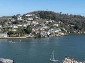 A view of houses on a hill near a river with boats at Tides Door in Dartmouth