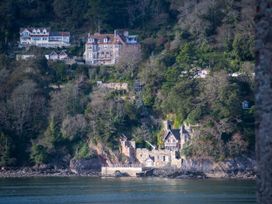 A view of houses on a hill by the water at Tides Door in Dartmouth
