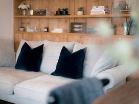 A living room with a sofa and bookshelf at 28 Piazza in St Ives