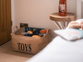 A toy basket and lamp in a bedroom at 28 Piazza St Ives