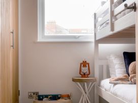 A bedroom with a bunk bed and side table at 28 Piazza in St Ives