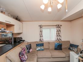 A living room with a sofa and window at 37 Redcar