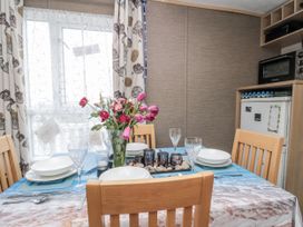 A dining room with a table set for meals at 37 in Redcar