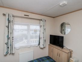 A bedroom with a window and television at 37 Redcar