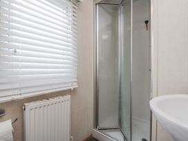 A bathroom with a shower and sink at 37 Redcar
