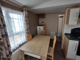A dining room with a table and chairs at Sands Retreat in Redcar