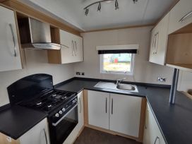 A kitchen with a sink and cooker at Sands Retreat in Redcar