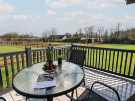 A table with a bottle and glass on a patio at Grass Roots in 