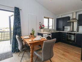 A kitchen with a table and chairs at Grass Roots in 