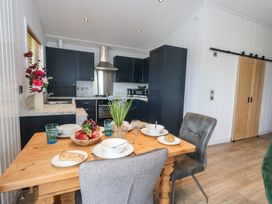 A kitchen with a dining table and chairs at Grass Roots