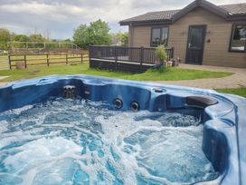 A hot tub with bubbles in an outdoor area at Grass Roots in Henstridge near Stalbridge