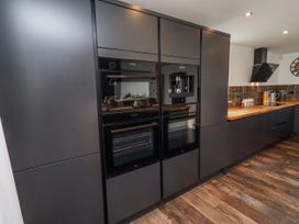 A kitchen with modern appliances at The Joiners Cottage in Birling near Warkworth